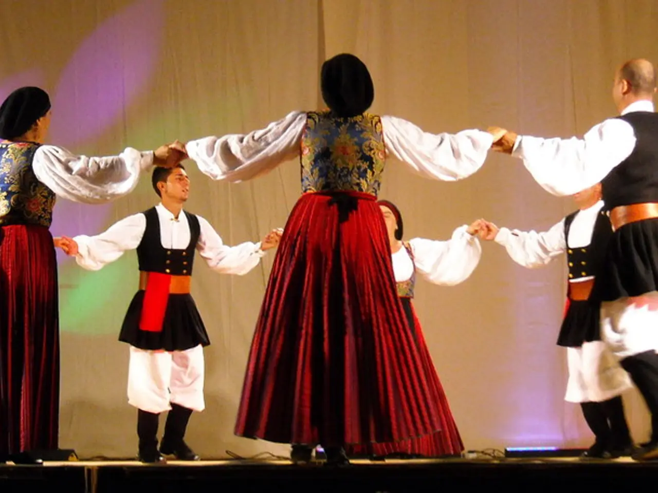 Here men and women are standing holding hands.