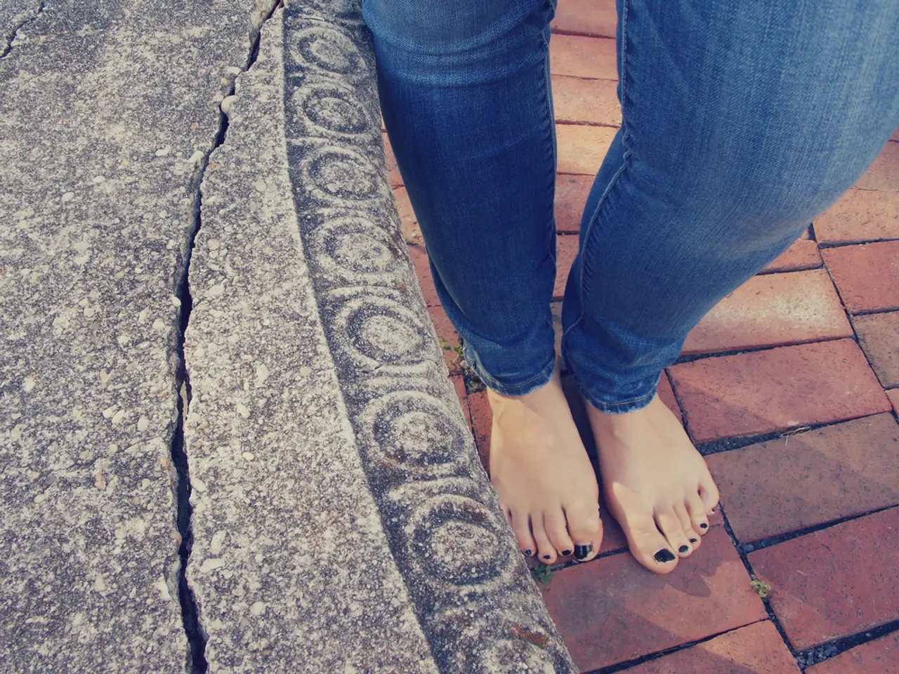 On the left side, there is a broken wall. On the right side, there are two legs of a person on a...