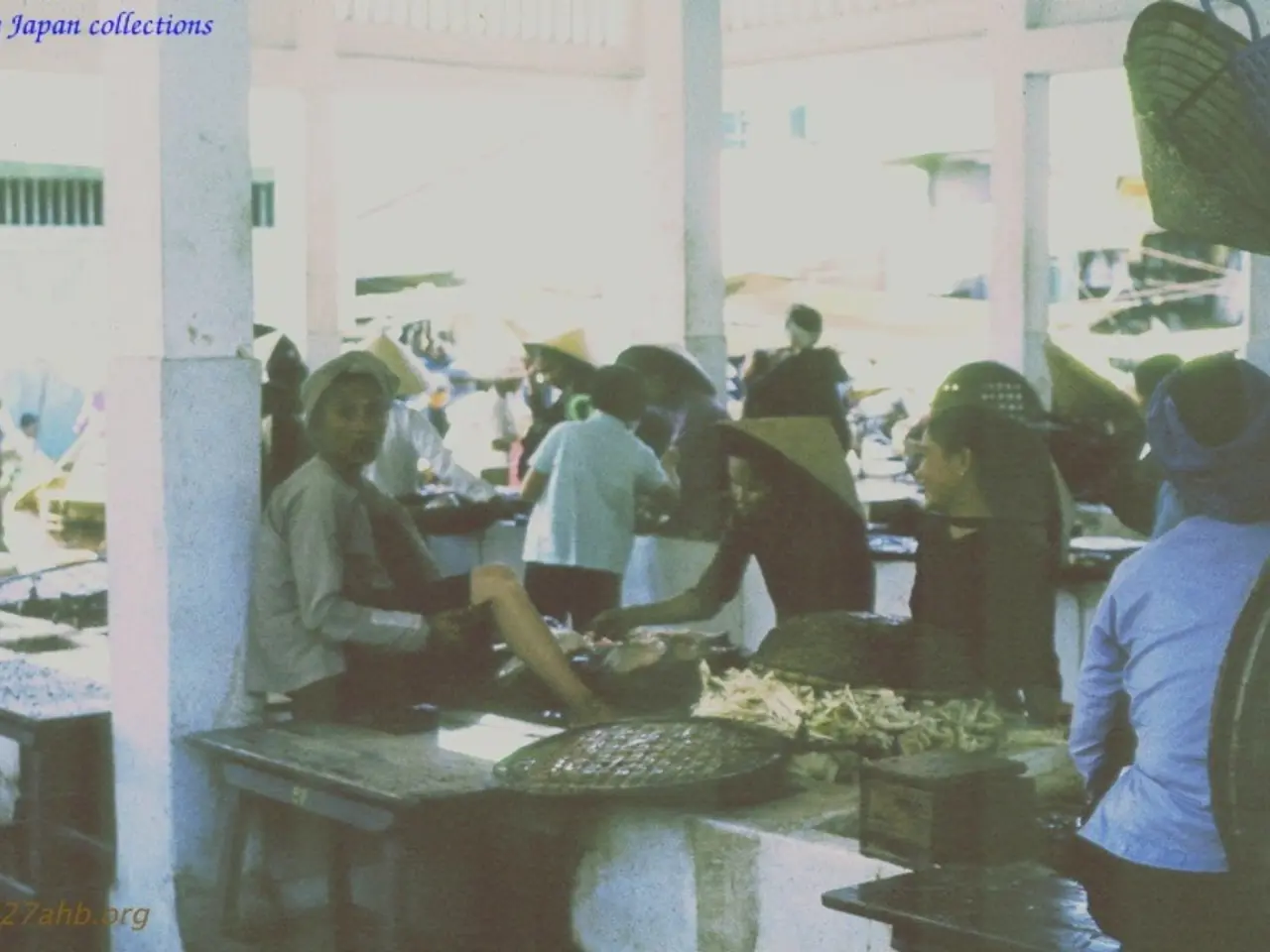 In this image I can see number of people were few are sitting and few are standing. I can also see...