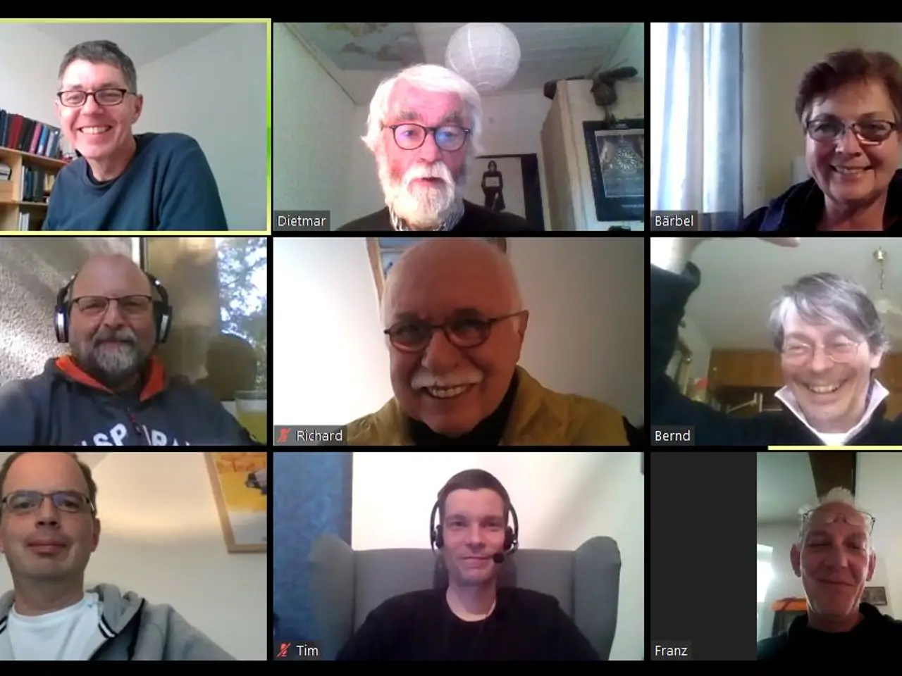 The image shows a group of people on a video call, all wearing headsets and smiling. In the...