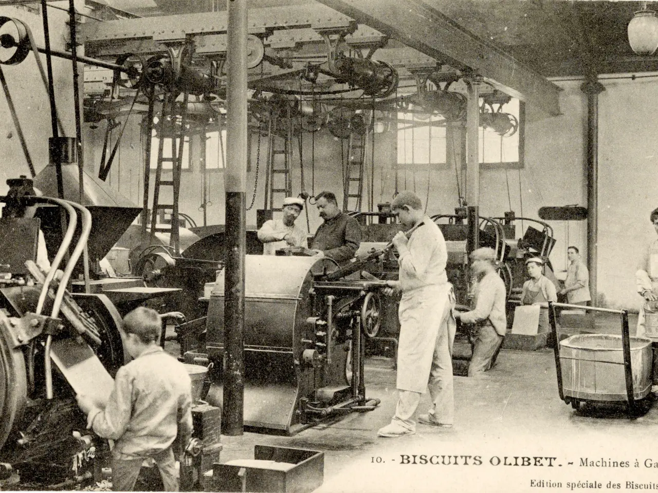 The image shows a group of men working in a factory, with machines, ladders, poles, lights,...