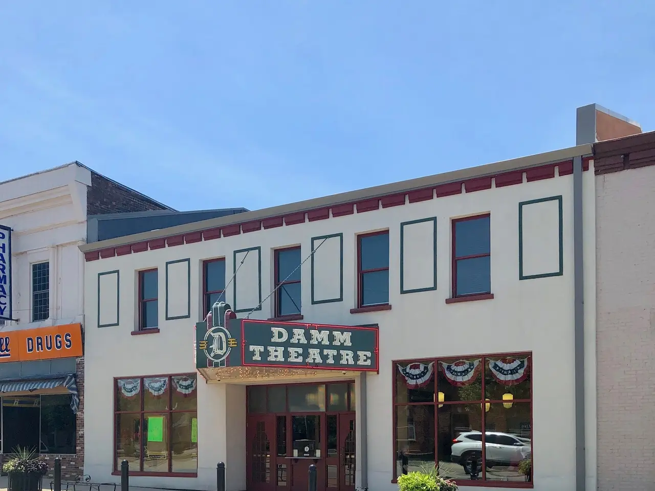 The image shows the Damm Theatre in St. Louis, Missouri. It is a building with windows and doors, a...