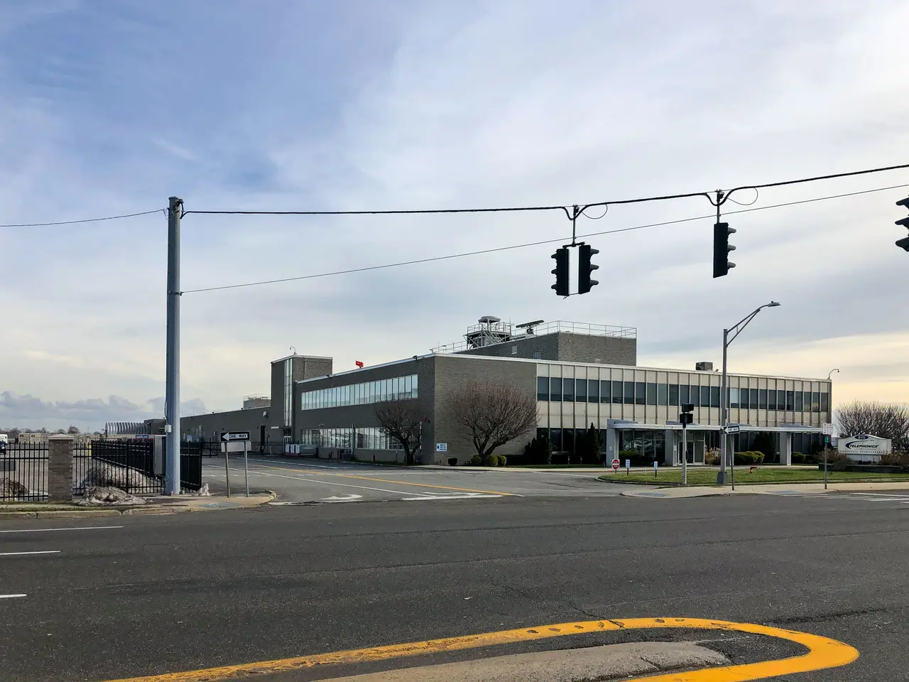 The image shows a large building with a lot of traffic lights on the side of it, surrounded by...