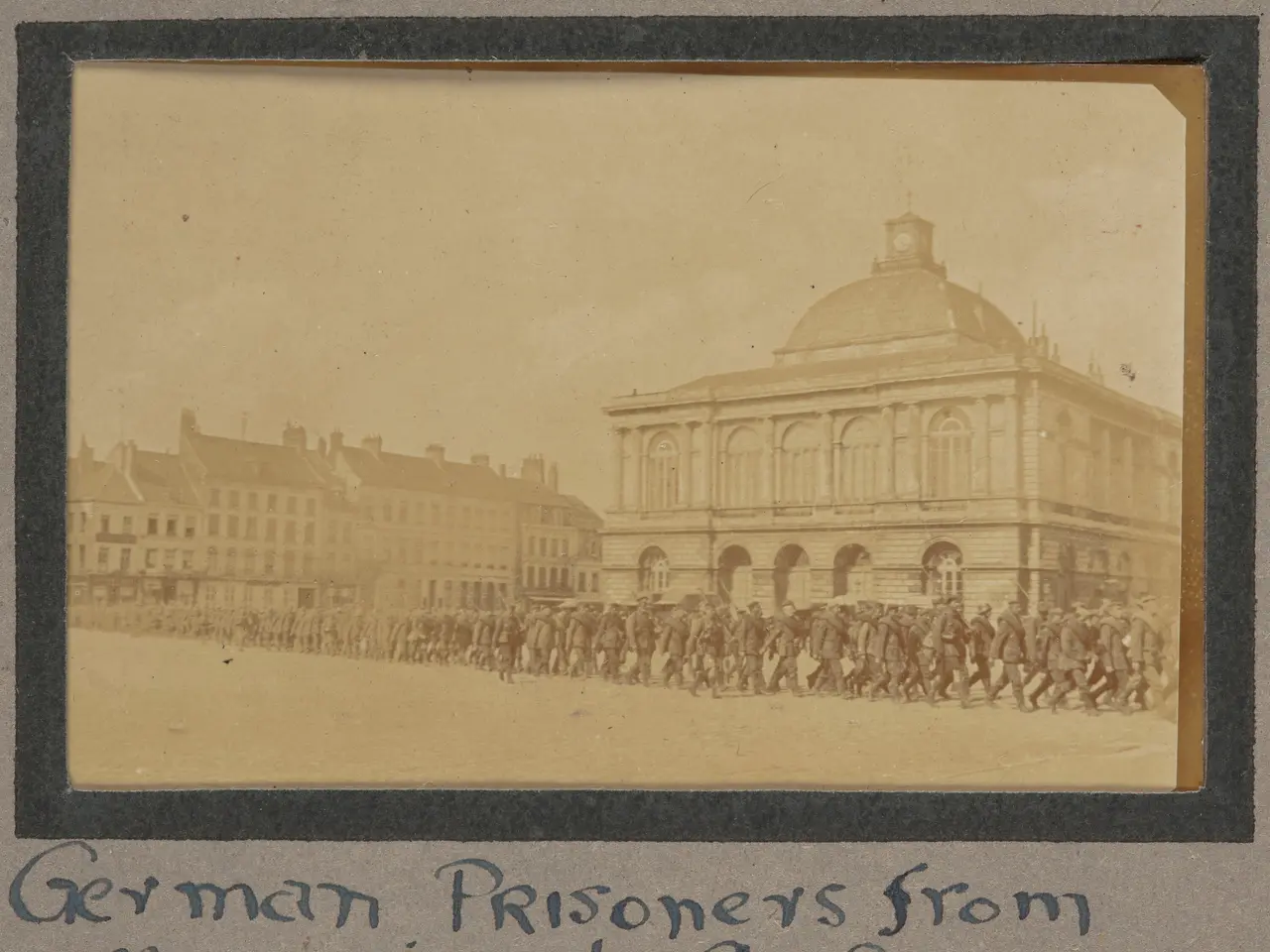 The image shows a group of German prisoners from Messines at St. Omer, standing in front of a...