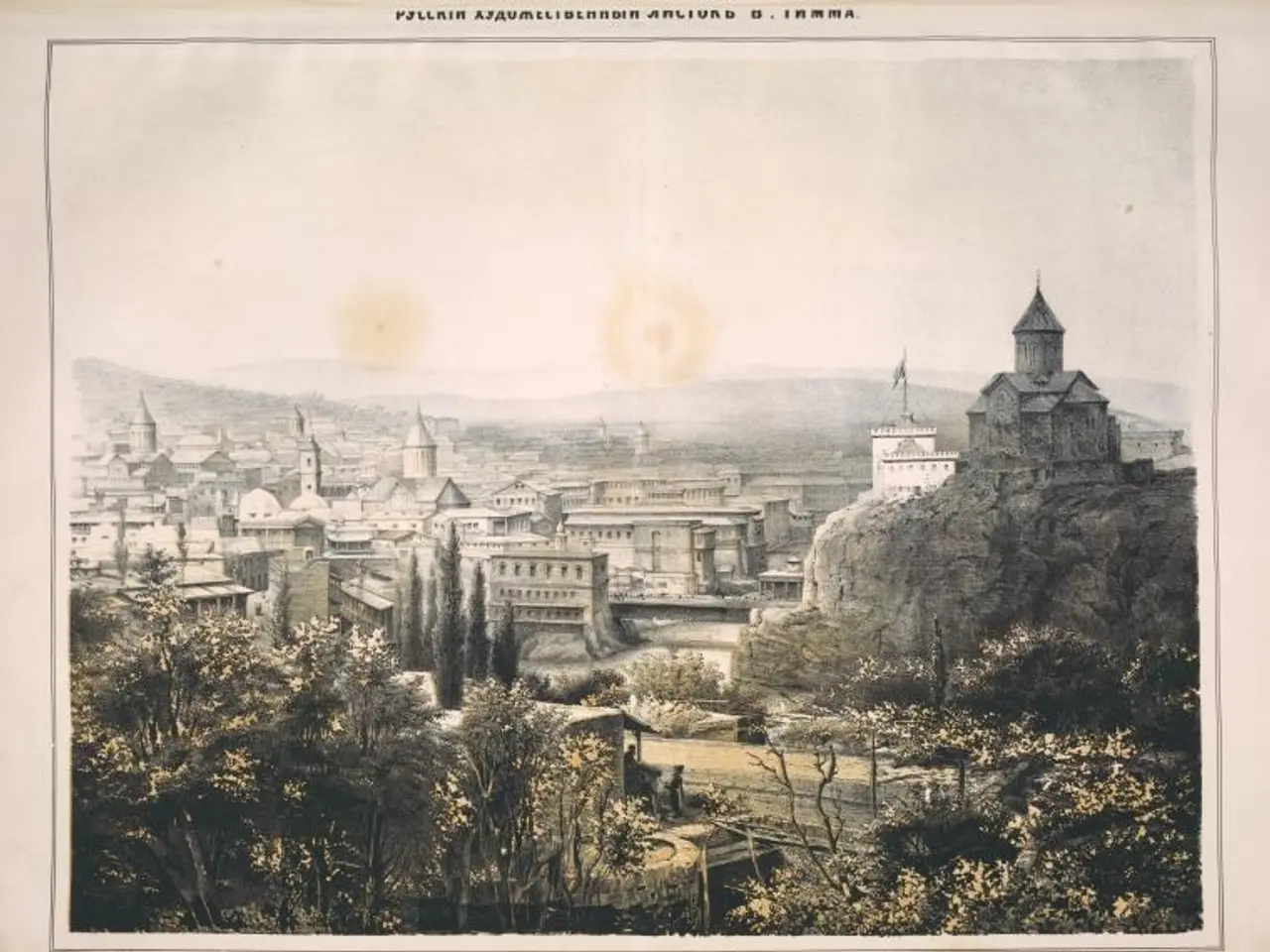 The image shows a view of the city of Tbilisi from the top of a hill, with trees, buildings, hills,...