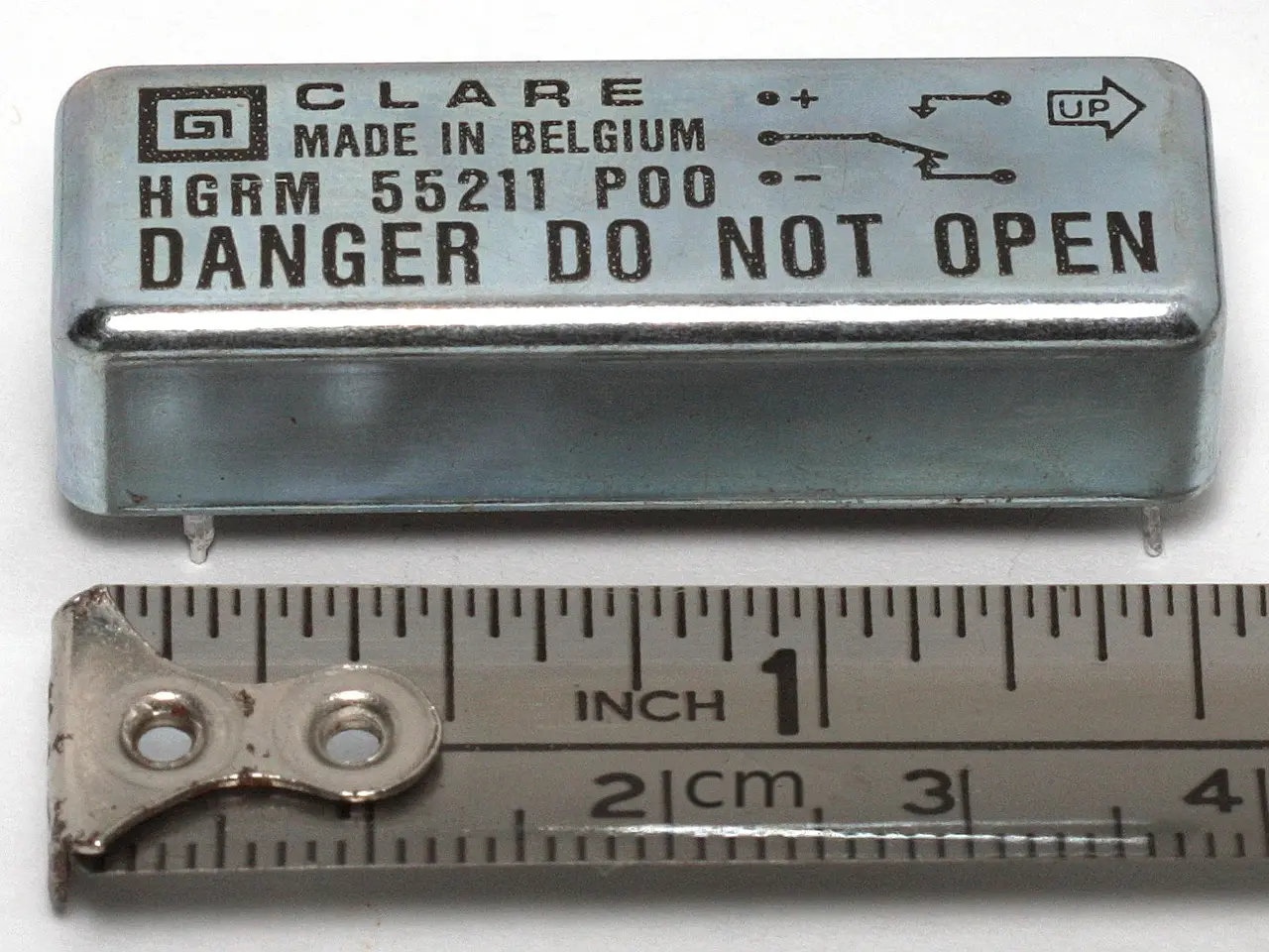 The image shows a metal box with the words "Danger Do Not Open" written on it, sitting next to a...