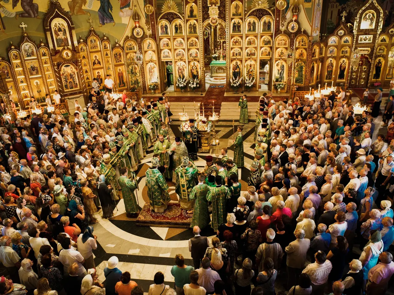 The image shows a large group of people standing in front of a church, with some of them holding...
