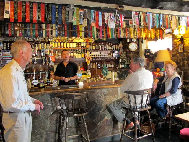 The picture is from a wine store. On the left there is a man standing. In the foreground there are...