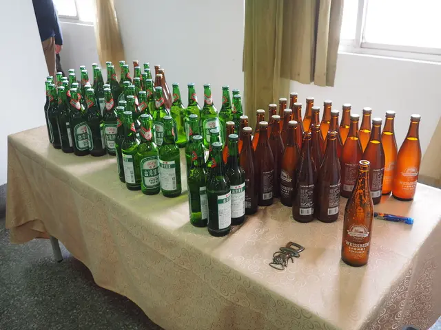 In the image there are many beer bottles on a table , on right side of it there is window with...