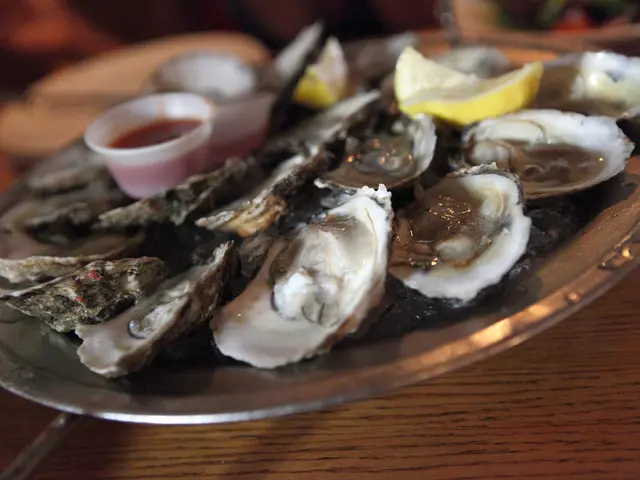 In this image there is a plate on which there are shellfish one beside the other. In the middle...