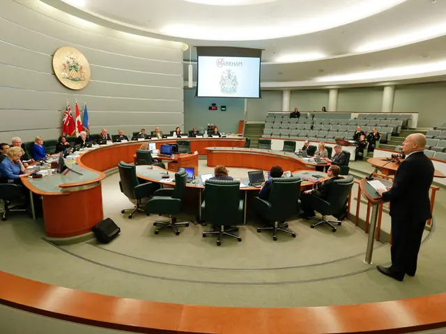 This is a conference room. Here we can see all the persons sitting on chairs in front of a table...