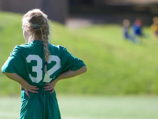 In the picture I can see a kid wearing green T-shirt is standing on a greenery ground in the left...