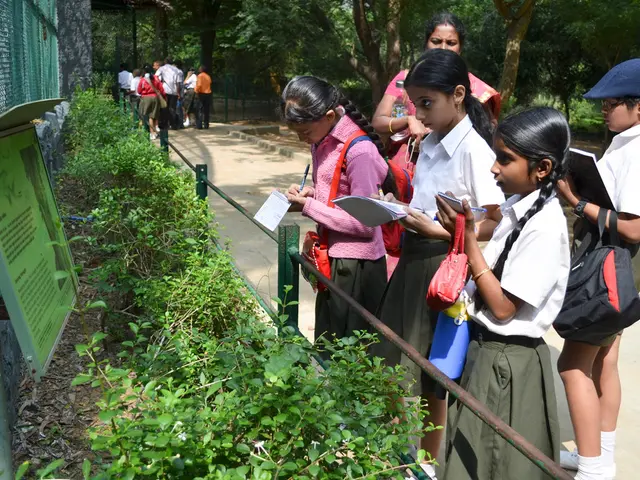 On the right side, we see four children are standing. They are writing something in their books....