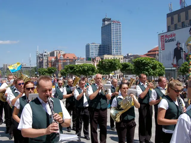 This picture is clicked outside. In the foreground we can see the group of persons wearing same...