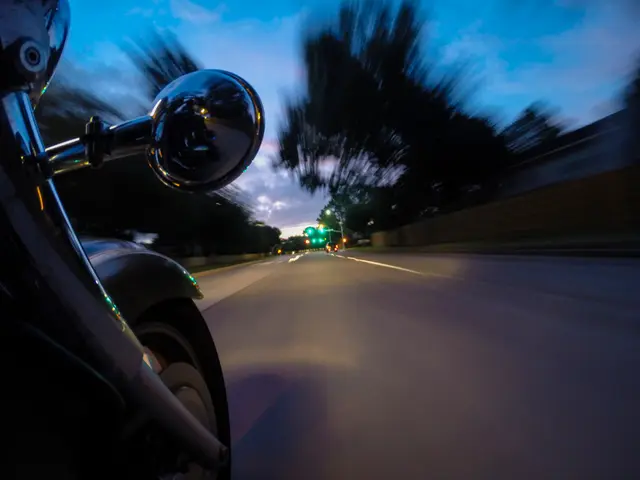 At the left side of the image there is a bike. In the center of the image there is a road. In the...