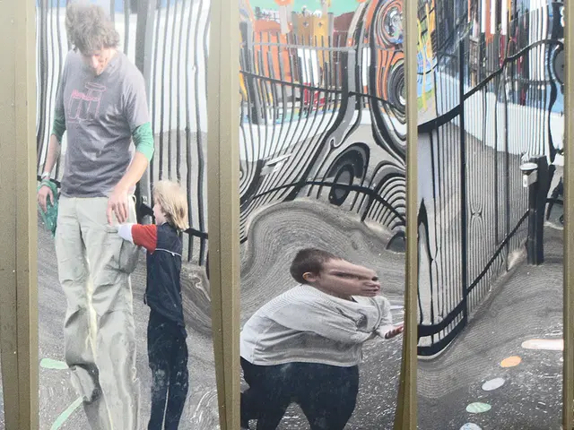 There is a mirror and the images of three people and a fencing is being reflected on the mirror.