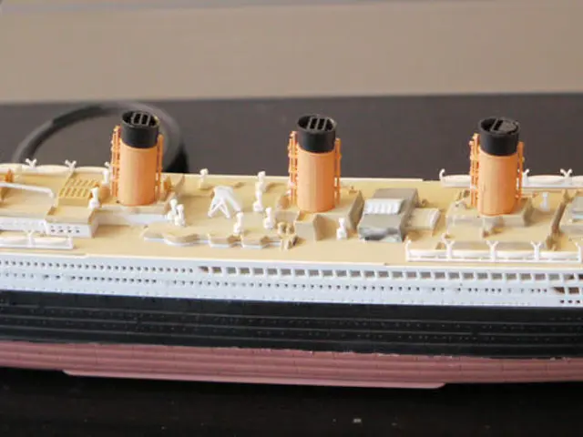 In this image I can see a toy ship in the front. I can see colour of the ship is cream, white,...
