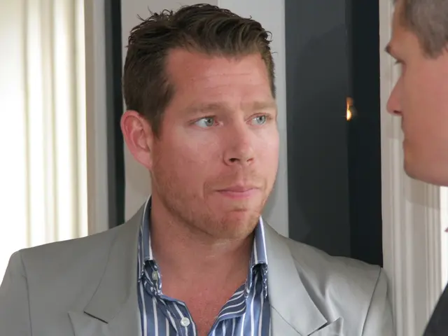 In this picture I can see there are two men standing and they are wearing blazers, there is a...