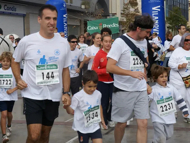 Here we can see crowd. Background there are buildings, hoardings and trees.
