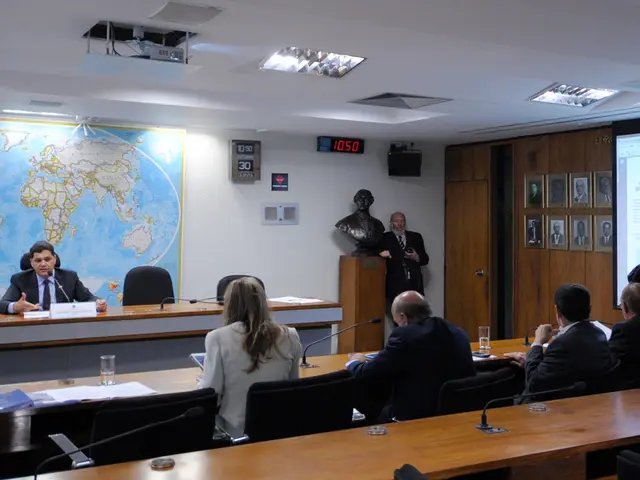 In the image we can see there are people who are sitting on chair and there is a man who is...