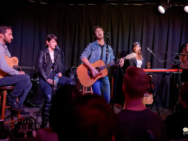 There are five members in this stage. Two of them were playing guitars in their hands and remaining...