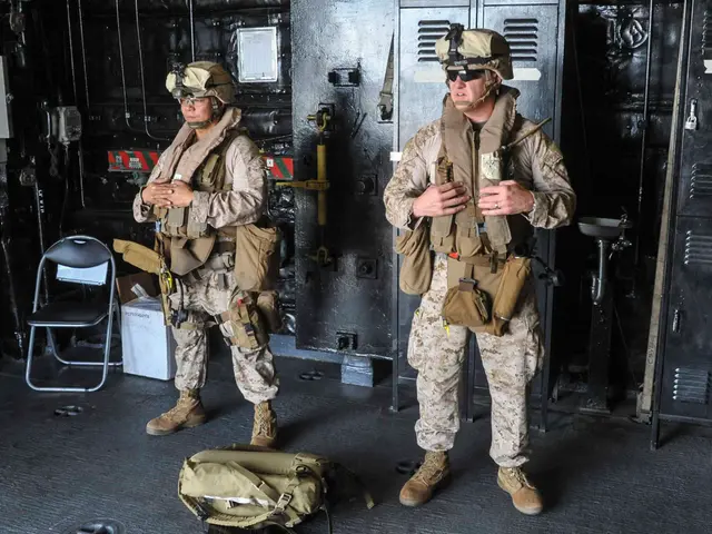 In this picture there are two soldiers standing and there is a bag in front of them and there is a...