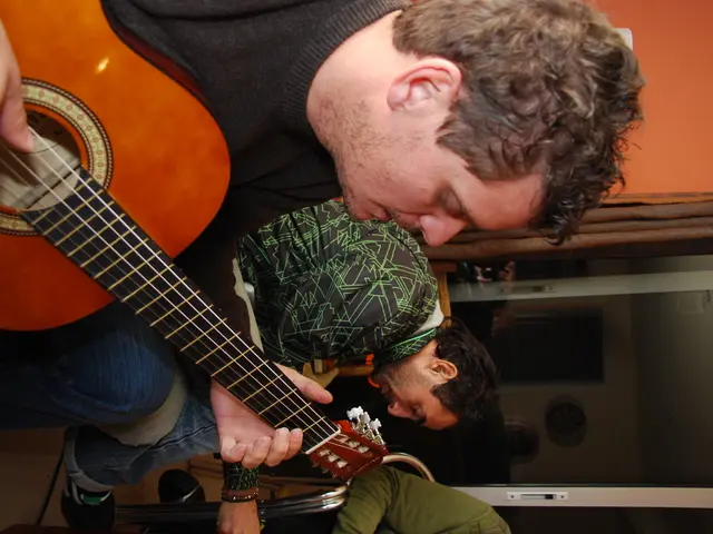 This image consists of three persons. There is a door behind them. All of them are sitting. The one...