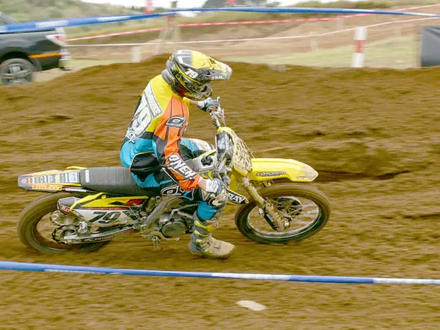 In this image I can see in the middle a person is riding a bike, this person is wearing the dress...