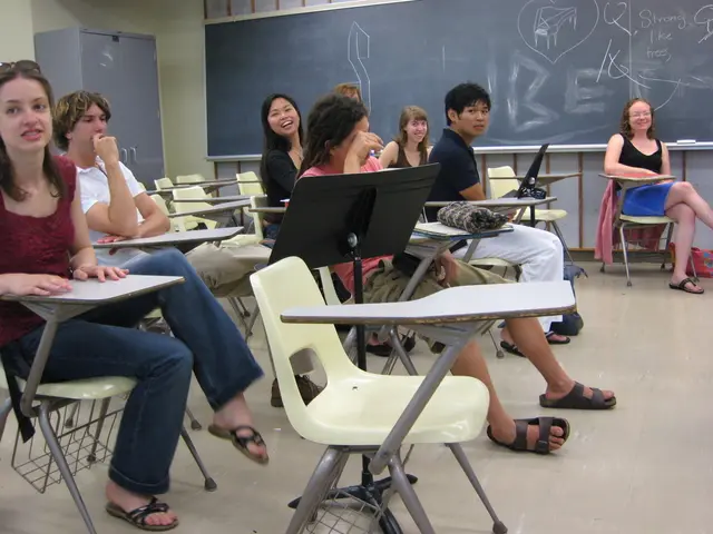 In this picture we can see 7 to 8 people who are sitting on chairs and the chairs are having boards...