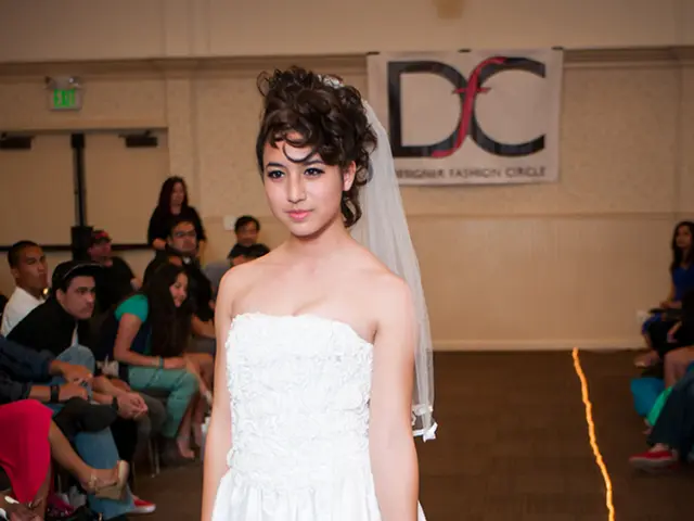 In front of the picture, we see a woman in the white dress is stunning. She is smiling and she is...