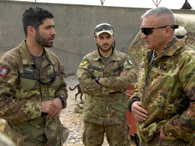 In this picture, we see five men in the uniform are standing. The man on the left side is talking...
