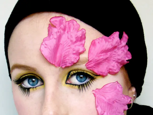 In this picture I can see a woman with different makeup.