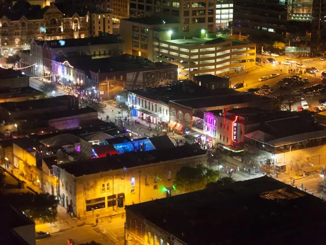 This image is taken outdoors. In this image there are many roads. Many people are walking on the...