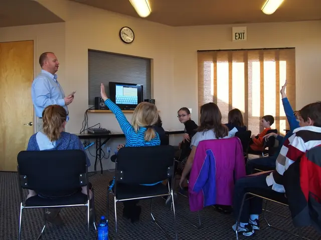 This looks like a classroom full of children was sitting on chairs and the man is standing and...