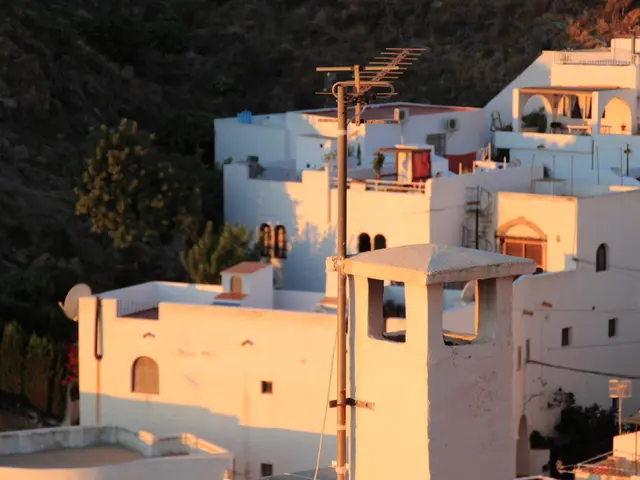 In this picture I can see there are few buildings and there is a pole here at the center and it has...