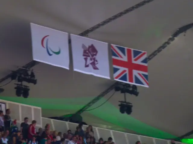 This picture is clicked inside. In the foreground we can see the group pf people and white color...