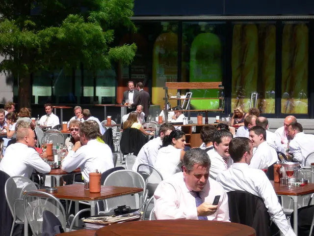 In this picture it seems to be a canteen, where all groups of people sitting on the tables and...