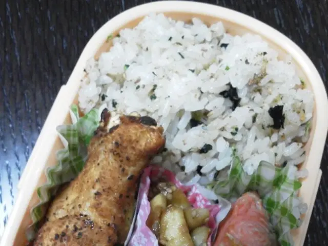 In this picture we can see box with tomatoes, food and papers on the wooden platform.