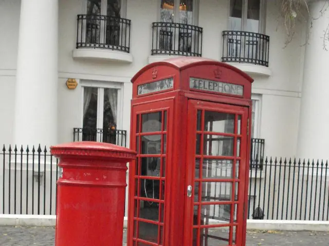This image consists of a post box and a telephone booth in red color. At the bottom, there is a...