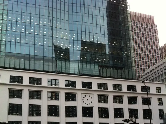 In this image I can see few carbs, few boards, a bus, few poles, number of buildings and I can see...