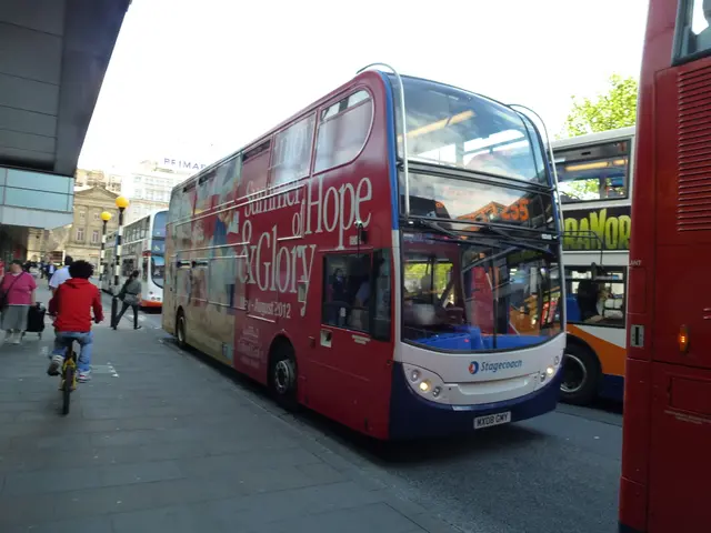 On the left side there is a sidewalk. On that there is a person riding cycle and there are many...