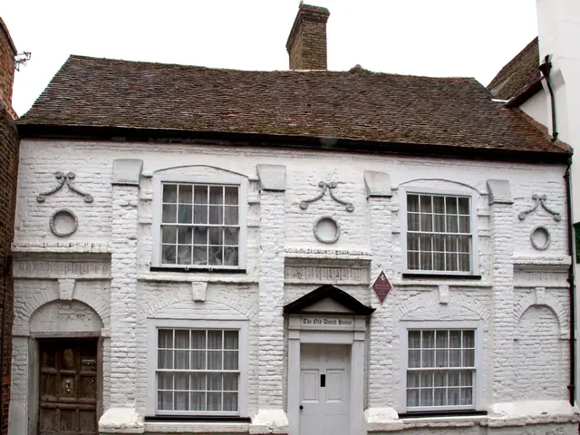 In this picture we can see white color house. On the top there is a brown color roofing tile and a...