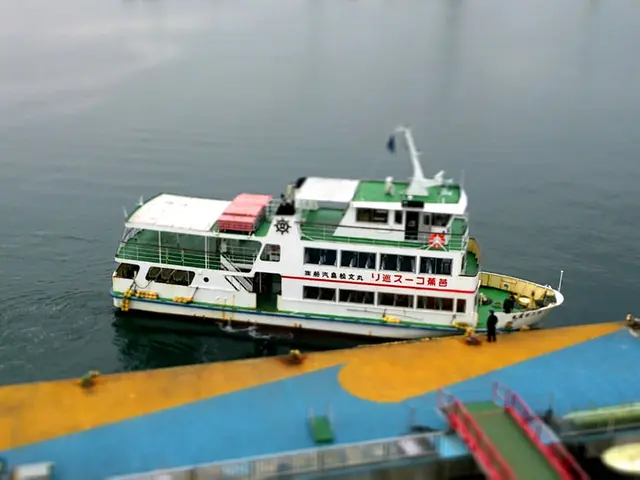 In the center of the image there is a boat. In the background of the image there is water. At the...