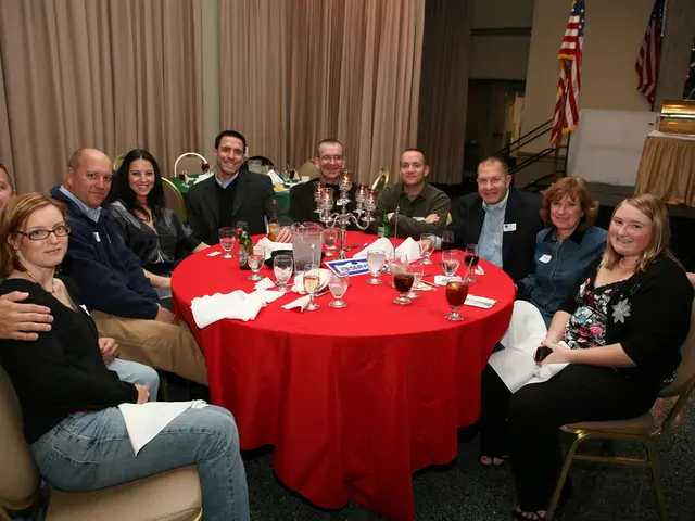 This picture shows a group of people seated on the chairs with a smile on their faces and we see...
