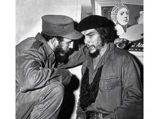 In this picture we can see two famous personalities talking with each other. In the background we...