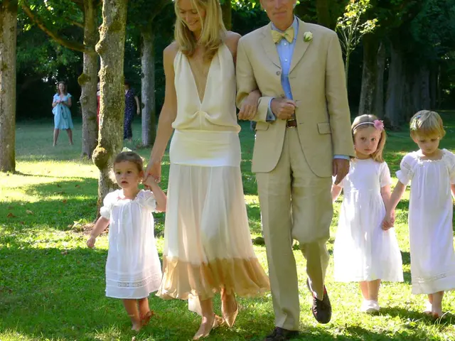 In this picture there is a man and woman in the center of the image and there are children on the...