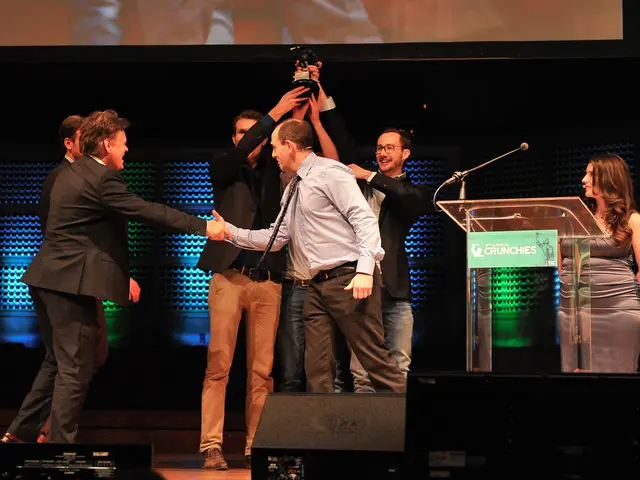 In the middle 2 men are lifting the prize with their hands and smiling. They wore black color...
