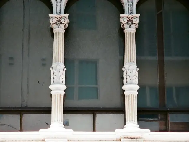 This image consists of a building. It has windows and pillars.