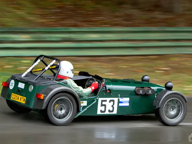 In this picture we can see a person is driving a car, this person is wearing a helmet, we can see a...