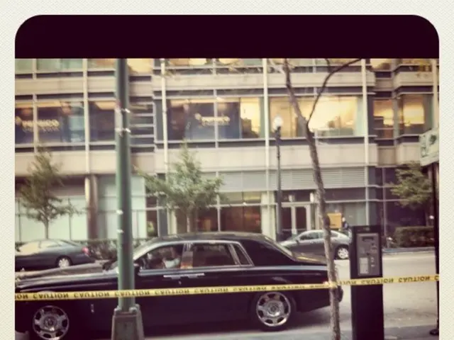 This is an image with the borders, in this image in the center there is one car and poles, trees....